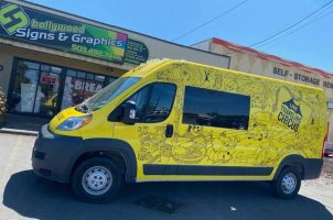 Traveling Circus yellow van with black graphics