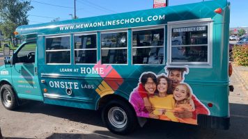 Teal colored school bus with colored decal