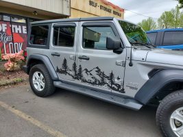 Gray jeep with mountain decal in black in OR