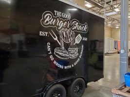 Black trailer with white decal from Hollywood Sign and Graphics